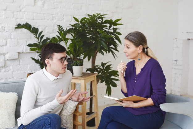oregon heroin addiction treatment man talking to female therapist in an oregon heroin rehab center